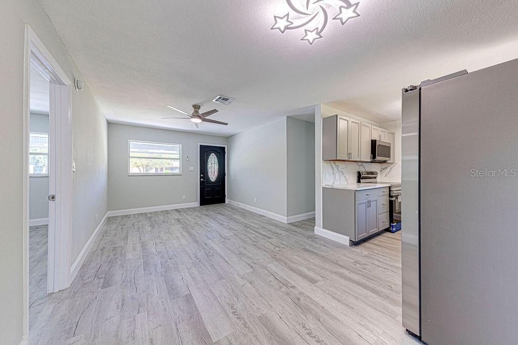 1133 Hermit Smith Road Apopka, FL 32712 - Photo 3 of 34 a view of kitchen with sink microwave refrigerator and cabinets