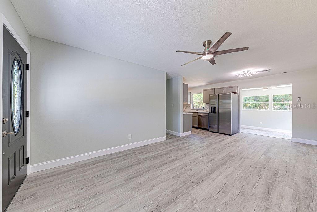 1133 Hermit Smith Road Apopka, FL 32712 - Photo 4 of 34 wooden floor in an empty room with a window
