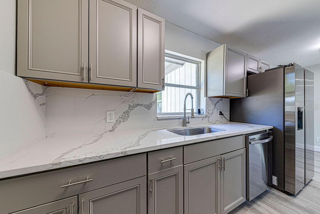 1133 Hermit Smith Road Apopka, FL 32712 - Photo 7 of 34 a kitchen with a sink and a refrigerator