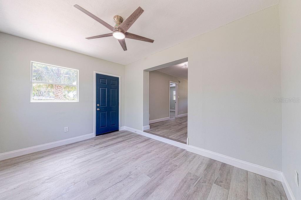 1133 Hermit Smith Road Apopka, FL 32712 - Photo 8 of 34 an empty room with wooden floor and windows