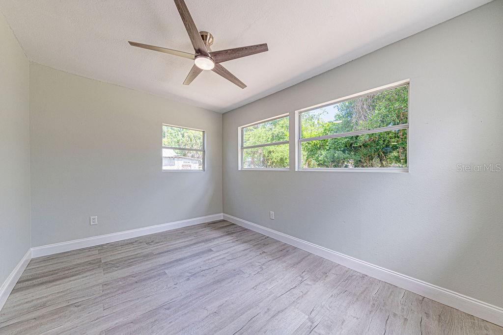 1133 Hermit Smith Road Apopka, FL 32712 - Photo 10 of 34 a view of an empty room with wooden floor and a window