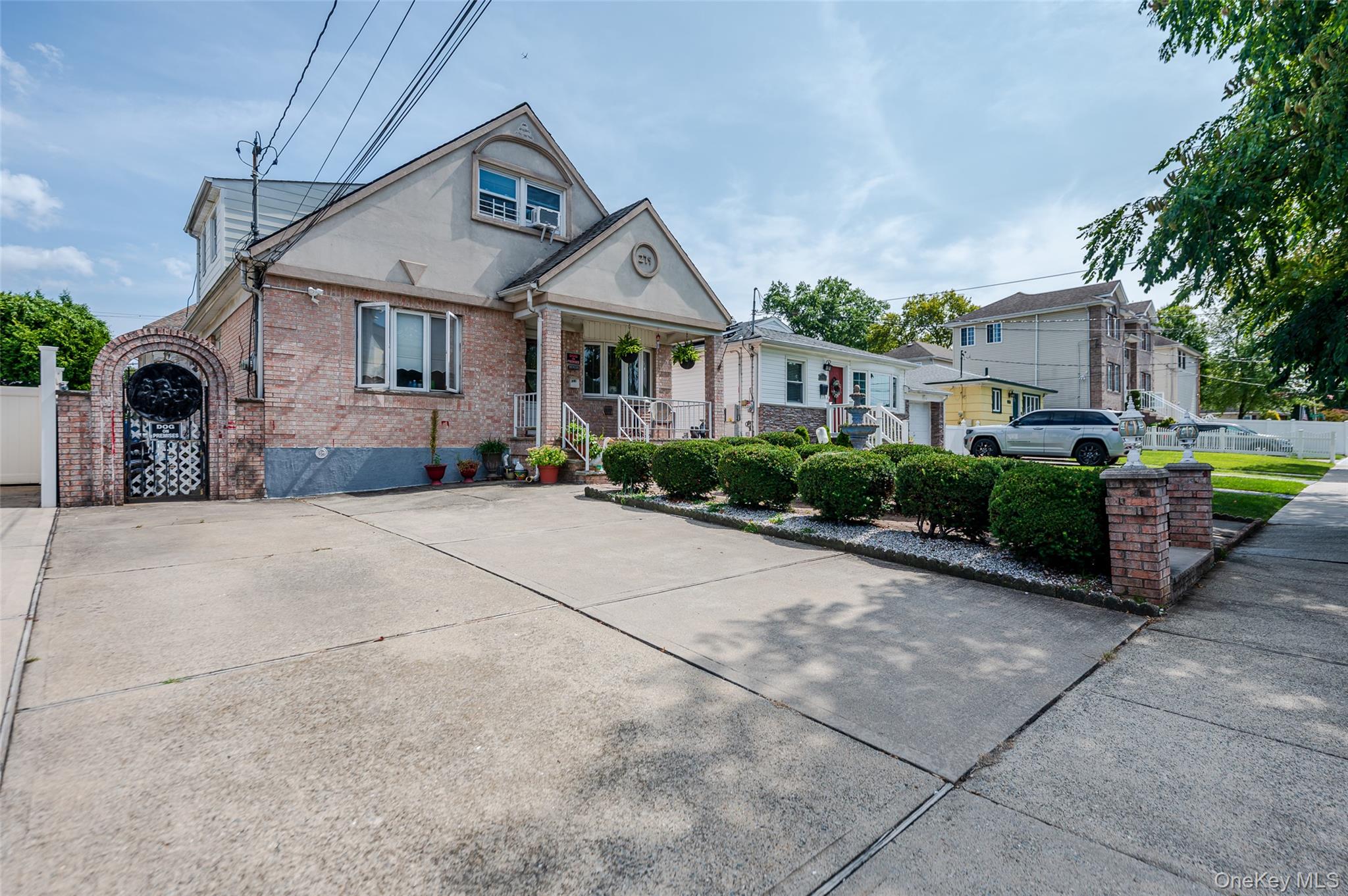 279 Collfield Avenue Staten Island, NY 10314 - Photo 41 of 41 View of front of home featuring brick siding, covered porch, and a gate