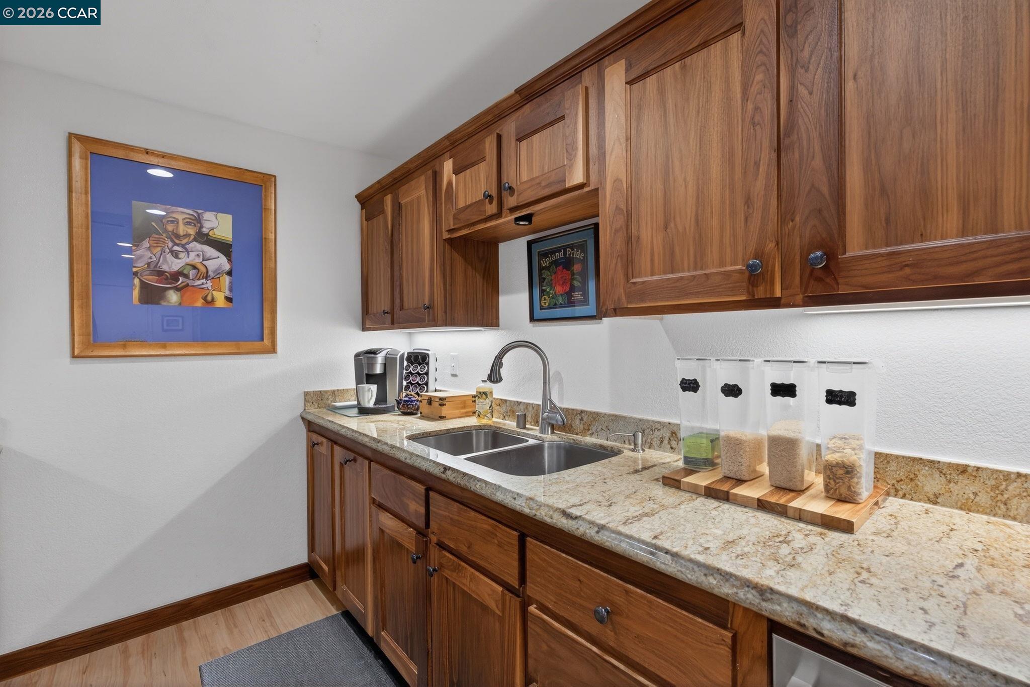 5015 Valley Crest Drive, Unit 121 Concord, CA 94521 - Photo 11 of 30 a kitchen with granite countertop a sink stove and cabinets