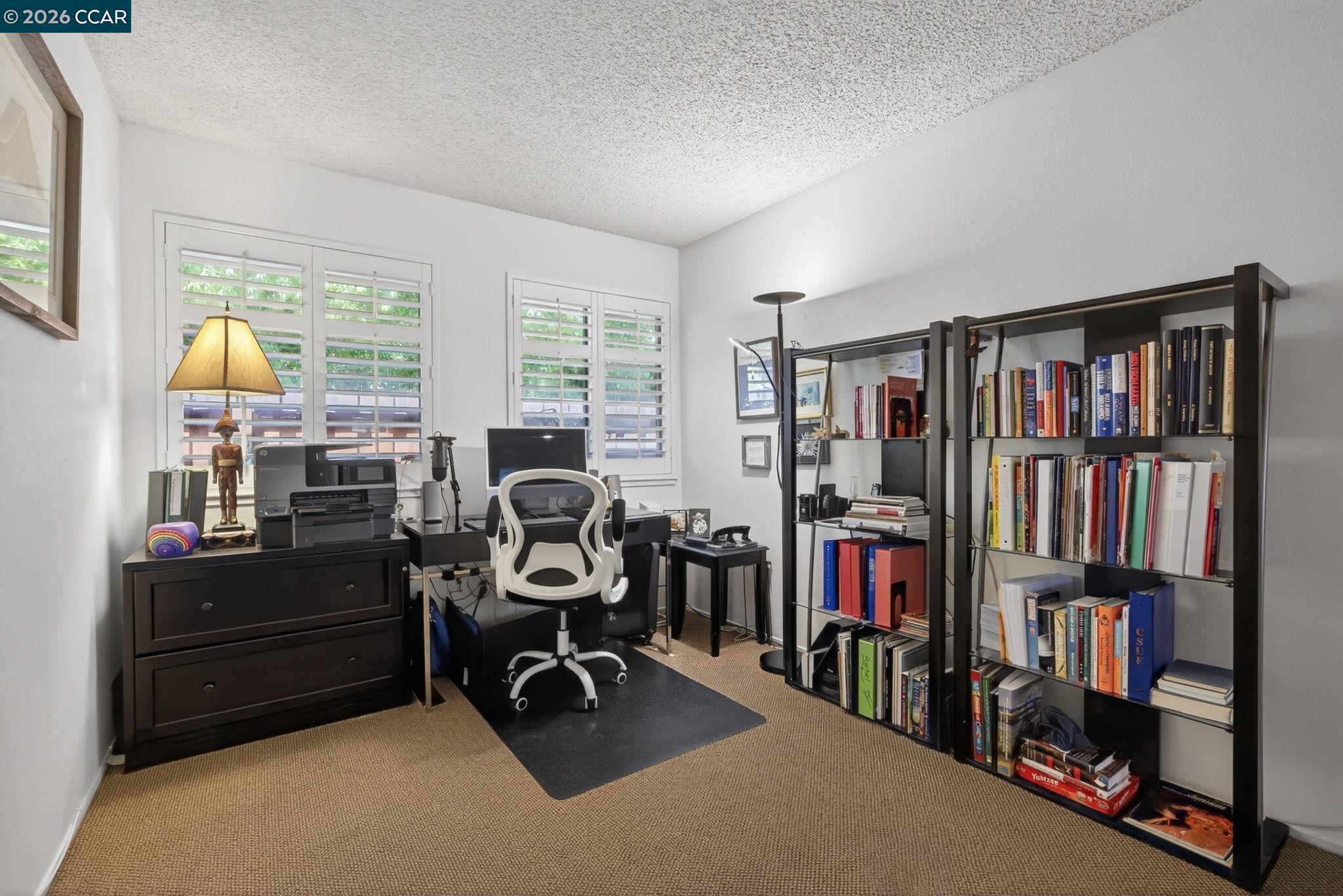 5015 Valley Crest Drive, Unit 121 Concord, CA 94521 - Photo 16 of 30 a view of a workspace with furniture and a bookshelf