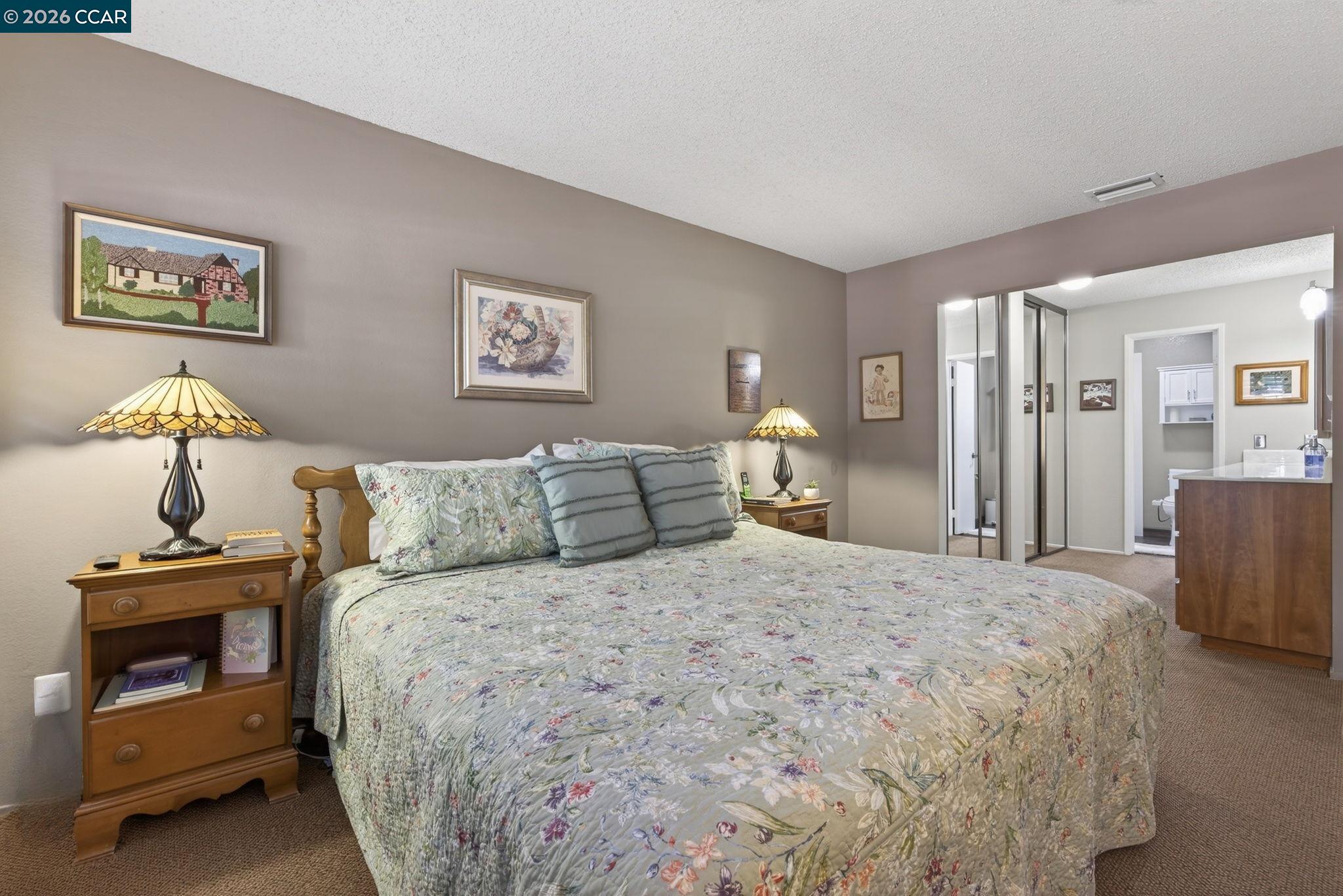 5015 Valley Crest Drive, Unit 121 Concord, CA 94521 - Photo 19 of 30 a bedroom with a bed and a chandelier