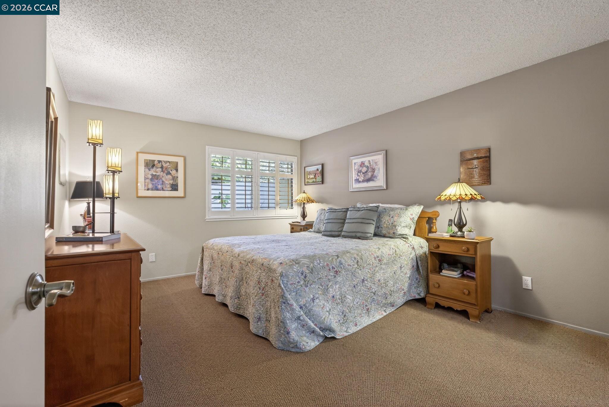 5015 Valley Crest Drive, Unit 121 Concord, CA 94521 - Photo 20 of 30 a bedroom with a bed and a chandelier