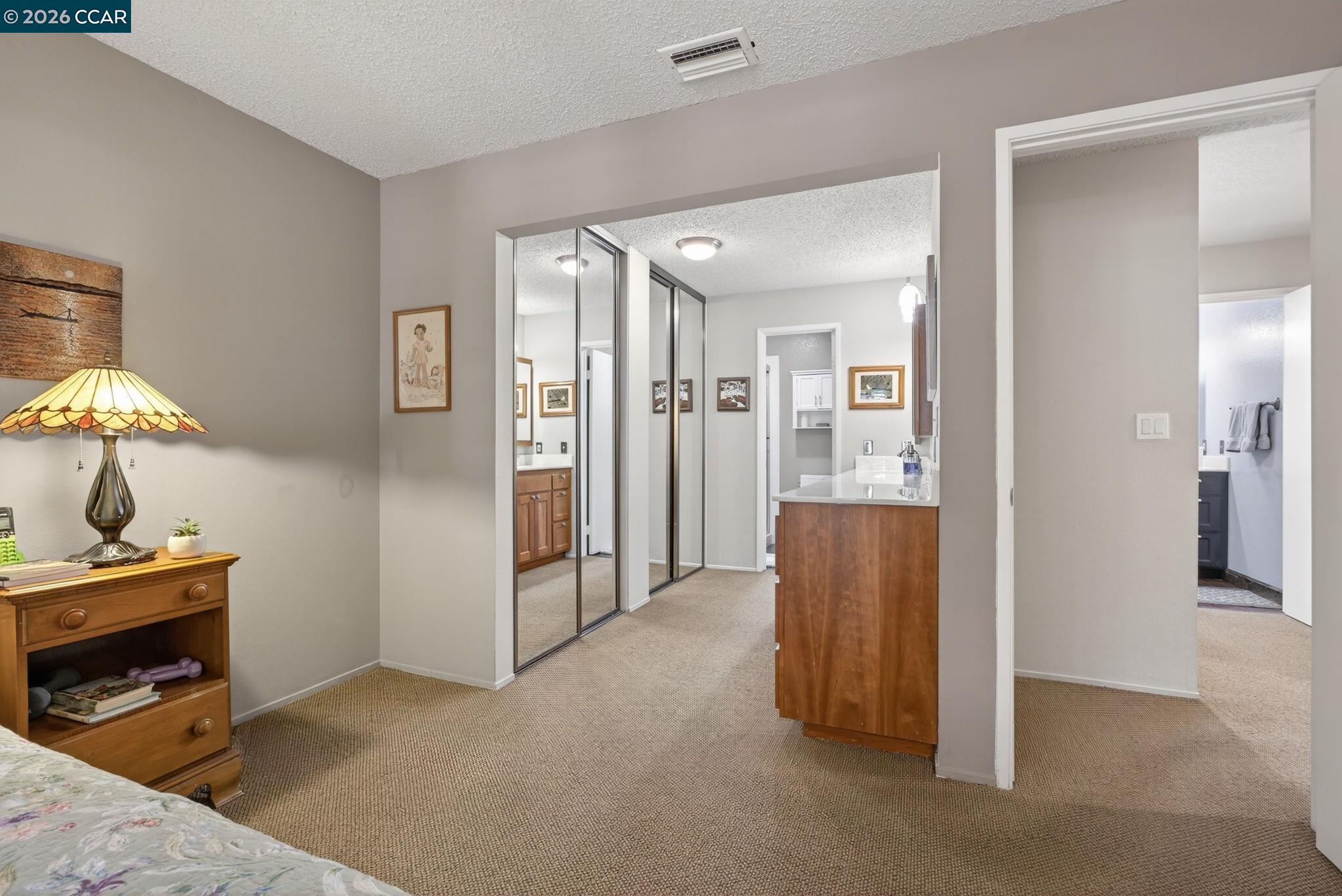 5015 Valley Crest Drive, Unit 121 Concord, CA 94521 - Photo 21 of 30 a view of a hallway with cabinet and mirrors