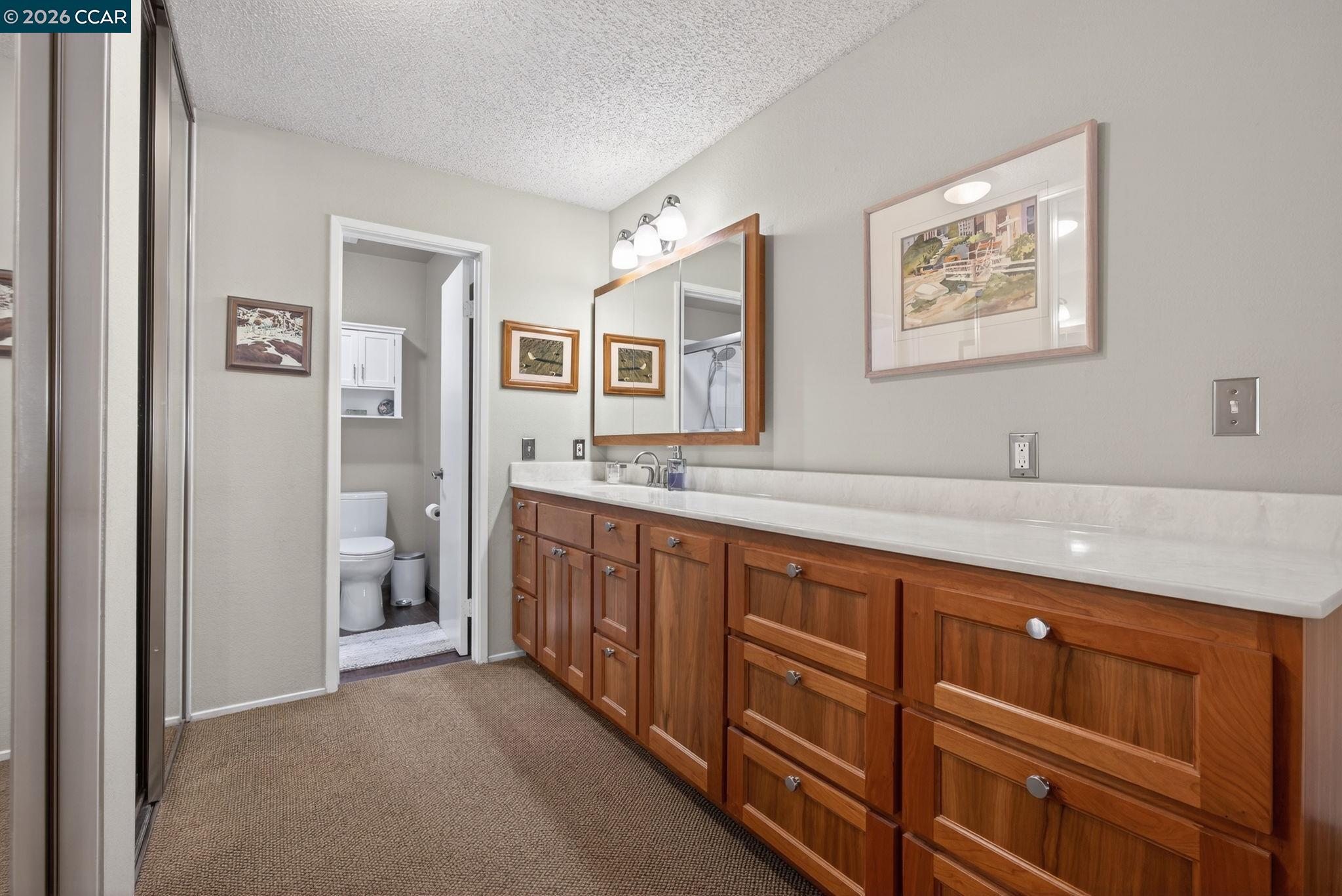 5015 Valley Crest Drive, Unit 121 Concord, CA 94521 - Photo 23 of 30 a spacious bathroom with a granite countertop sink and a mirror