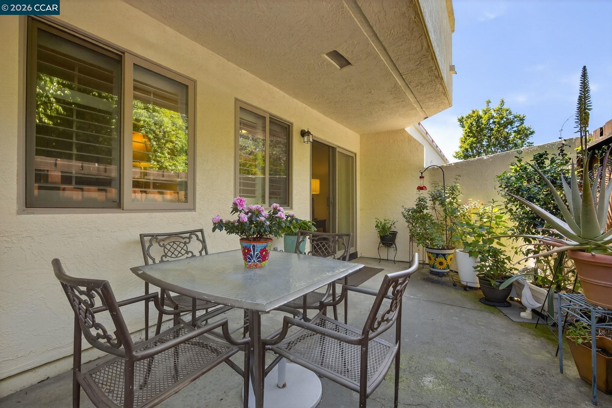 5015 Valley Crest Drive, Unit 121 Concord, CA 94521 - Photo 25 of 30 a view of an outdoor dining space with a table and chairs