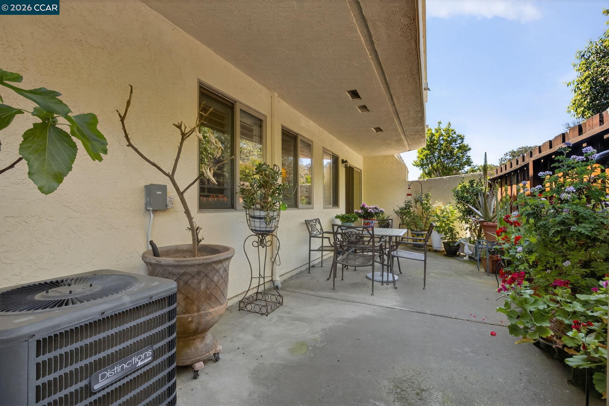 5015 Valley Crest Drive, Unit 121 Concord, CA 94521 - Photo 26 of 30 a view of a patio with table and chairs and potted plants
