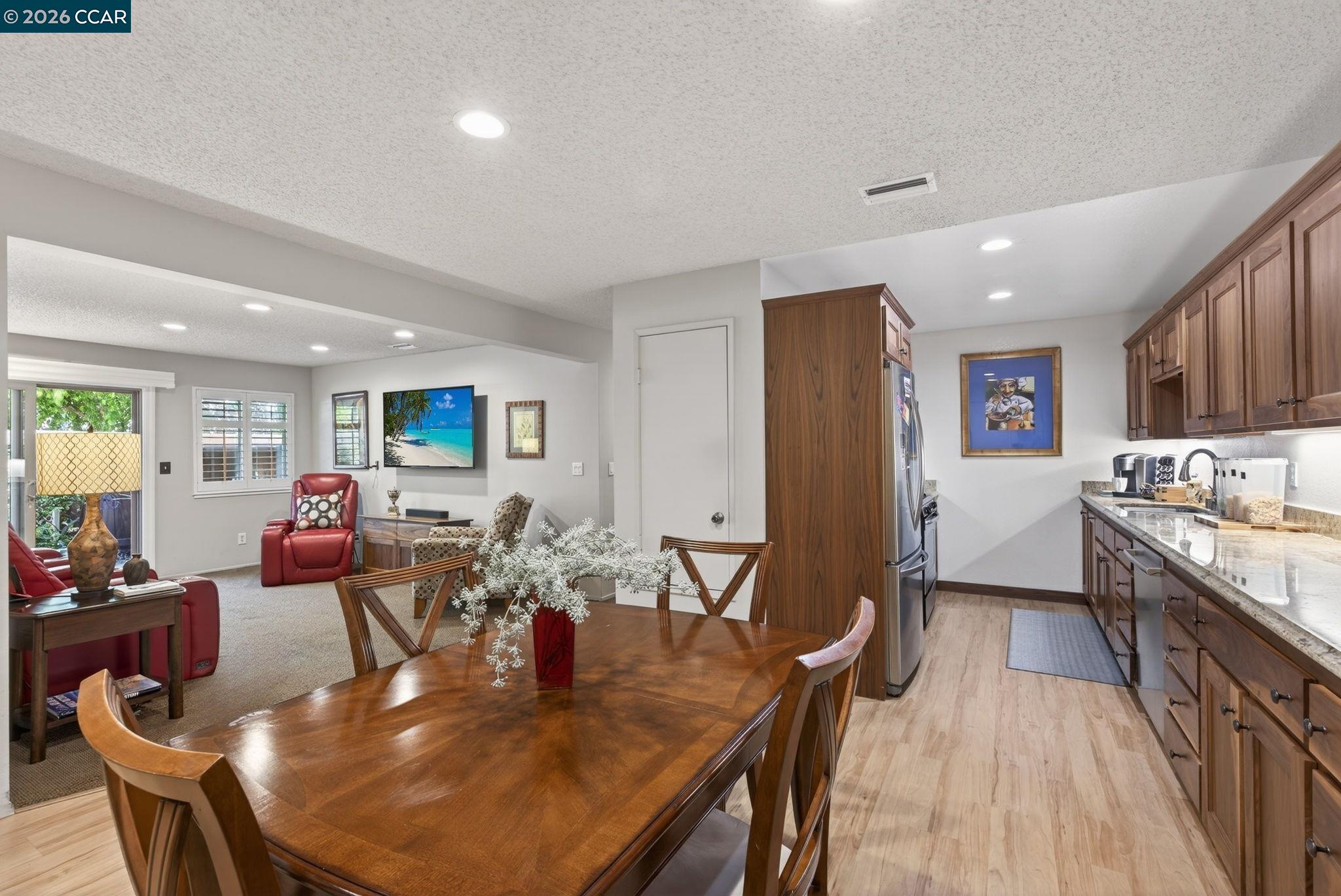 5015 Valley Crest Drive, Unit 121 Concord, CA 94521 - Photo 6 of 30 a dining room with furniture and wooden floor