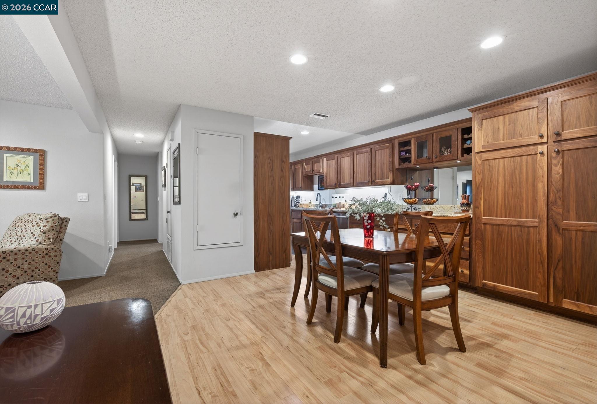 5015 Valley Crest Drive, Unit 121 Concord, CA 94521 - Photo 7 of 30 a dining room with furniture and wooden floor