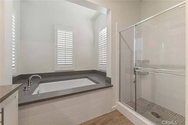 a bathroom with a granite countertop sink a mirror and a shower