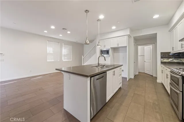 a kitchen with granite countertop a sink and a stove top oven