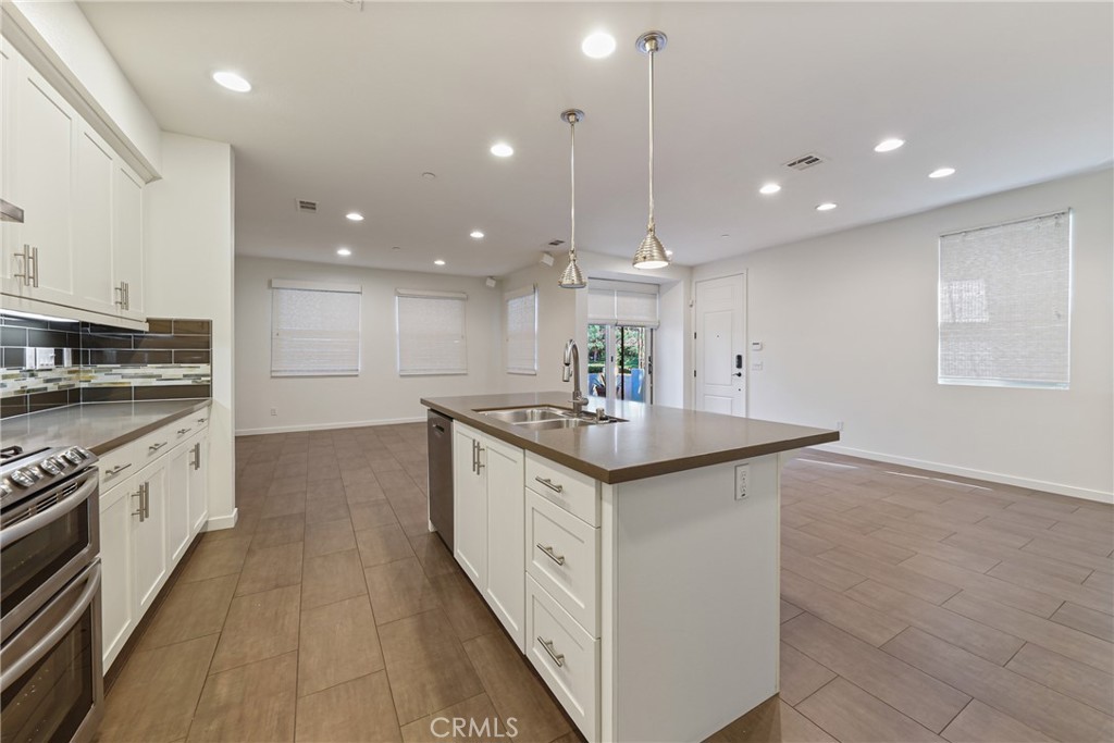 282 Borrego Irvine, CA 92618 - Photo 6 of 24 a kitchen with stainless steel appliances granite countertop a sink a stove and a refrigerator