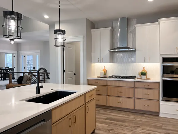a kitchen with stainless steel appliances a sink stove and refrigerator
