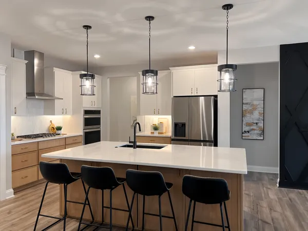 a kitchen with stainless steel appliances kitchen island a refrigerator and a stove