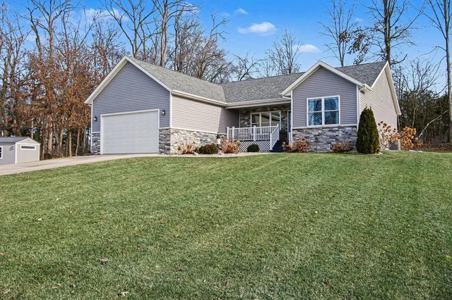 a view of a yard in front of a house with large tree