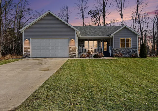 a front view of a house with a yard and garage