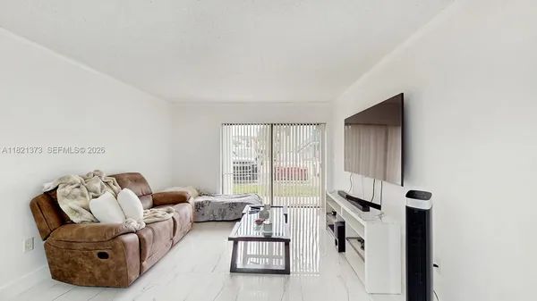 a living room with furniture and a window