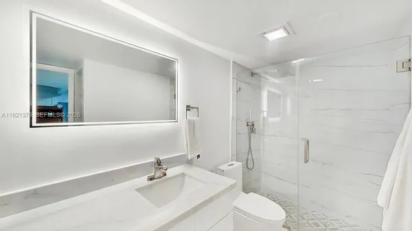a bathroom with a sink toilet and shower
