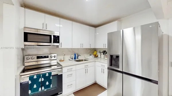 a kitchen with stainless steel appliances a refrigerator stove and microwave