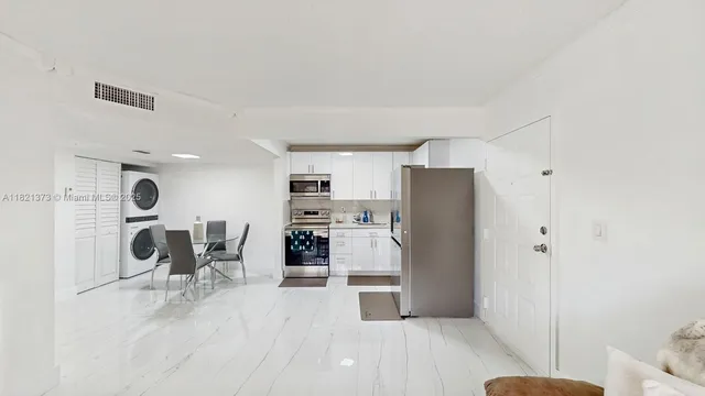 a kitchen with stainless steel appliances a refrigerator and a stove top oven