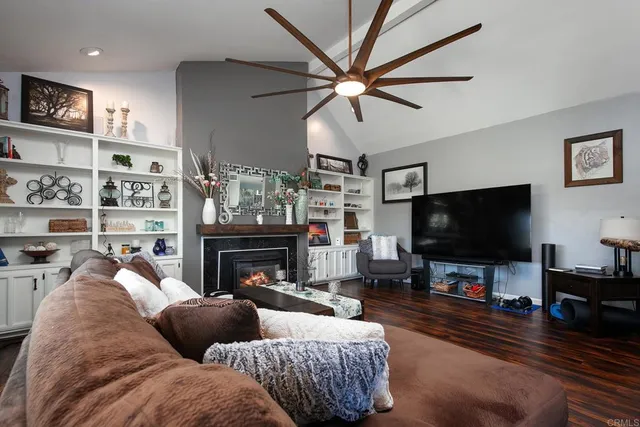 a view of a dining room with furniture large windows and wooden floor