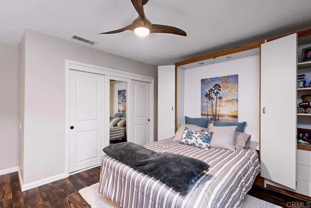 a spacious bedroom with a large bed and a dresser