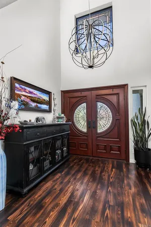 a large living room with stainless steel appliances granite countertop a couch and a large window