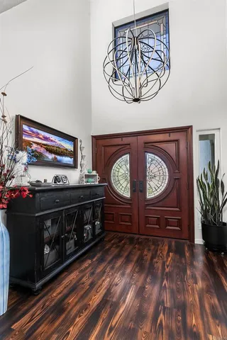 a large living room with stainless steel appliances granite countertop a couch and a large window