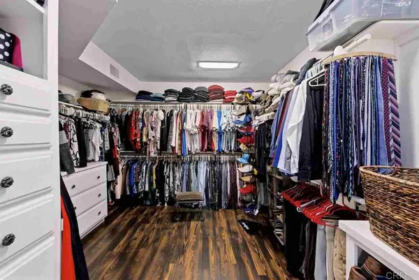 a view of a patio with couches table and chairs and potted plants