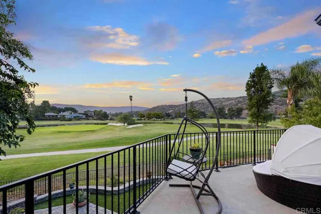 a view of a house with a big yard and large trees