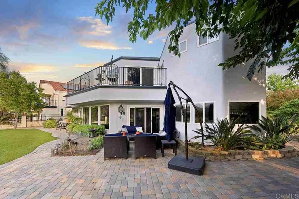a view of house with large windows and a park