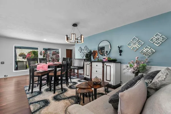 a living room with furniture flat screen tv and large window
