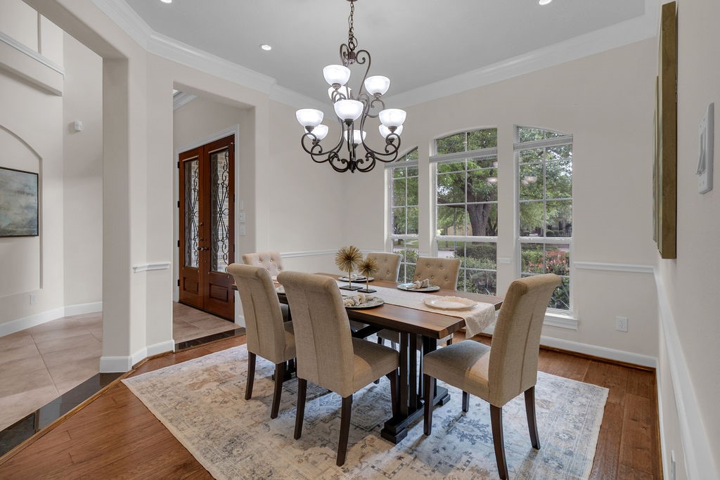 7306 Starflower Katy, TX 77494 - Photo 8 of 50 a view of a dining room with furniture a chandelier and wooden floor