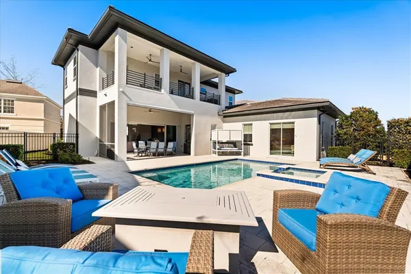 a view of a house with couches chairs and a fire pit