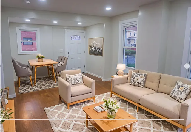 a living room with furniture a rug and a table