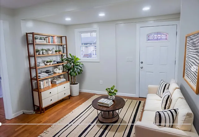 a living room with furniture and a potted plant