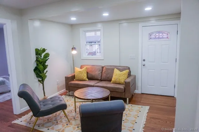 a living room with furniture and a potted plant