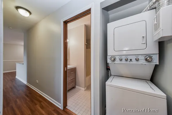 a view of washer and dryer with wooden floor