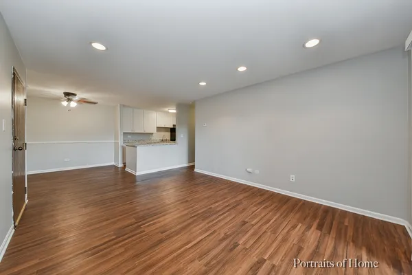 a view of a kitchen with wooden floor and a sink