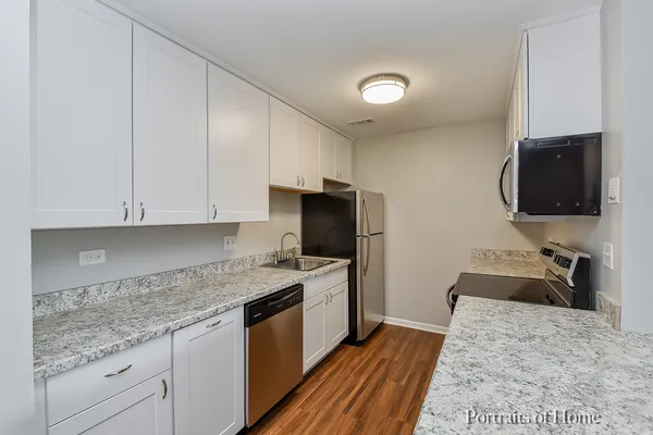 a kitchen with a sink stove and refrigerator