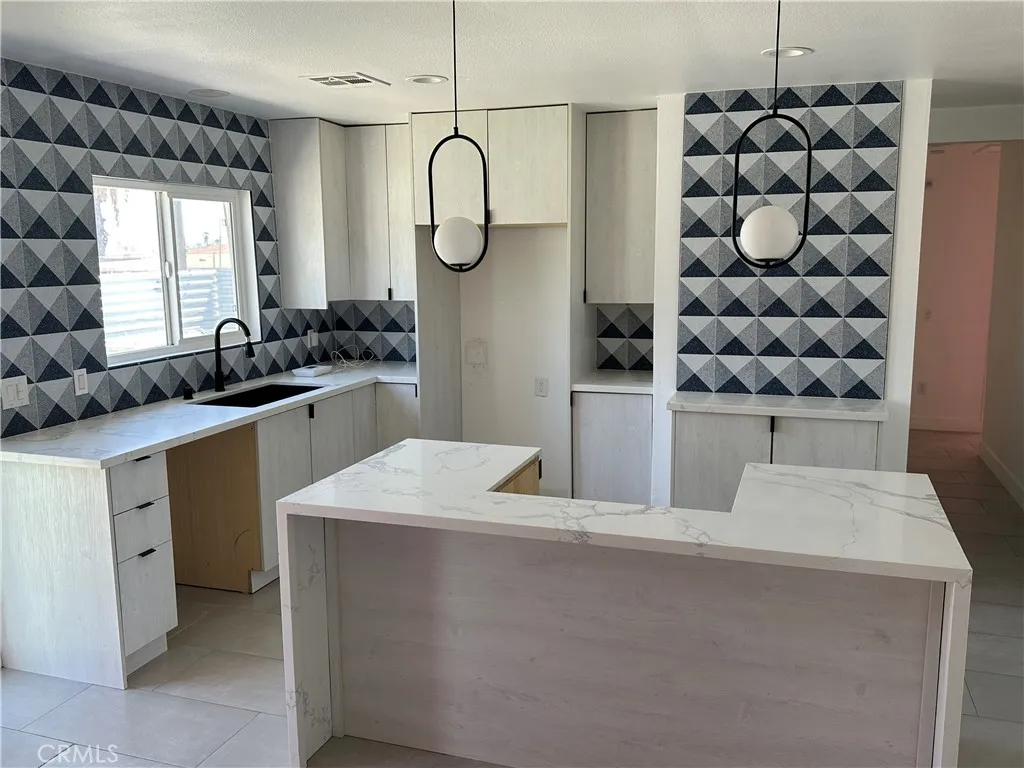 485 West Tramview Road Palm Springs, CA 92262 - Photo 12 of 16 a kitchen with a sink a stove cabinets and a window