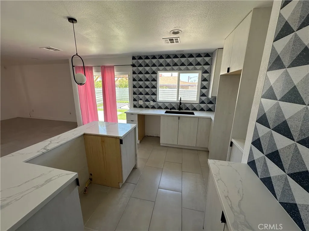 485 West Tramview Road Palm Springs, CA 92262 - Photo 14 of 16 a kitchen with granite countertop a sink and a stove