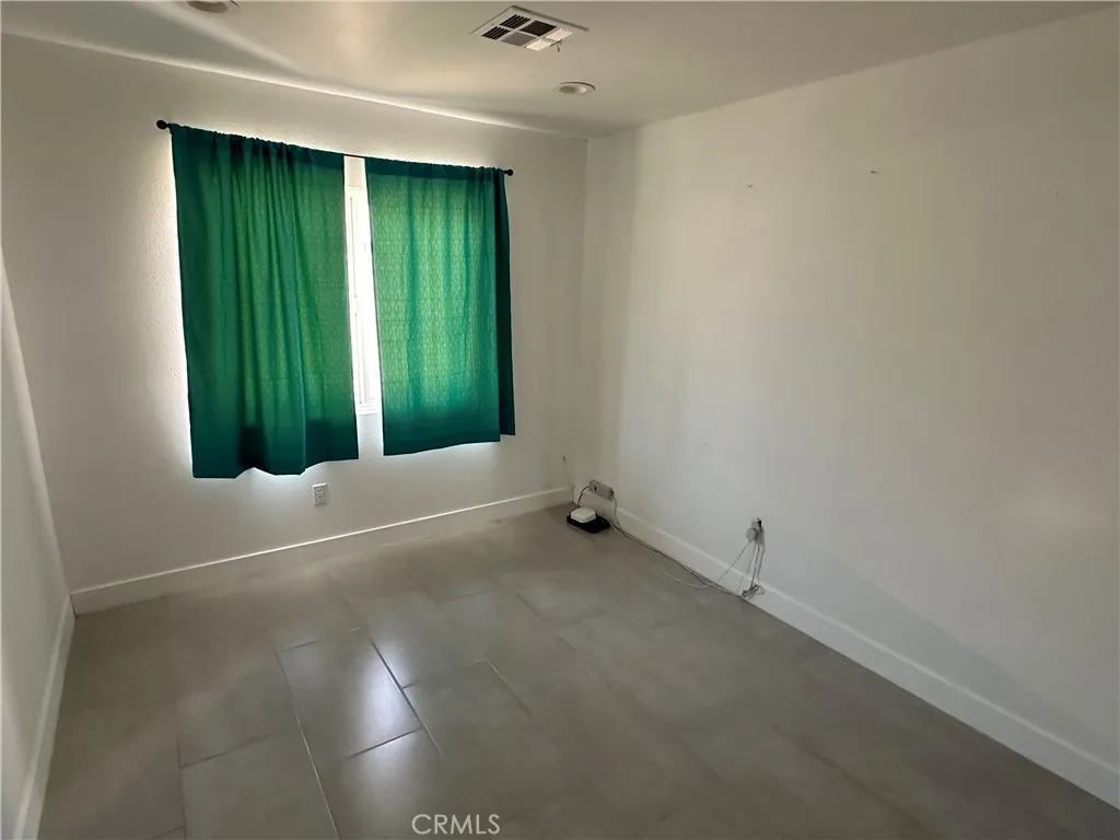 485 West Tramview Road Palm Springs, CA 92262 - Photo 9 of 16 an empty room with closet and windows