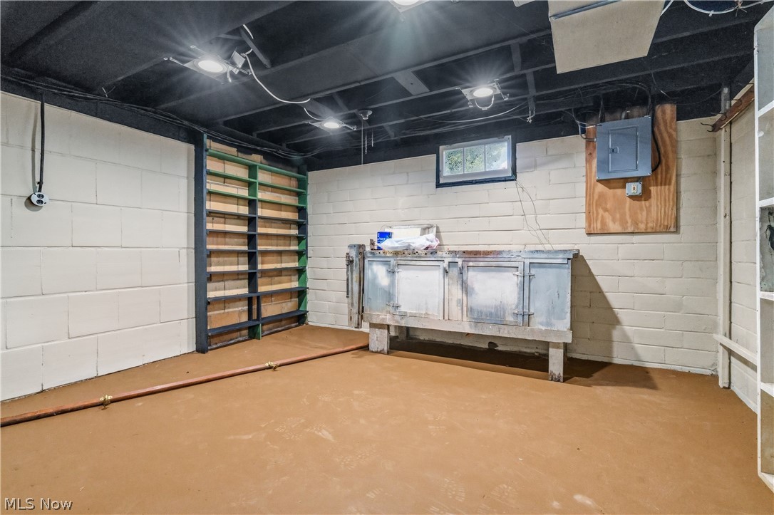1769 Paradise Road Orrville, OH 44667 - Photo 27 of 36 Lower level space featuring painted cinder block walls, exposed ceiling joists, and concrete flooring