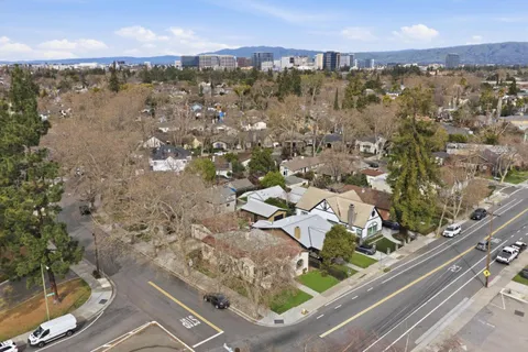 a view of a livingroom with a fireplace and chandelier