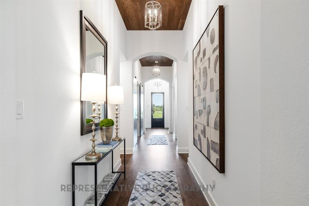 1609 Quartz Street Northlake, TX 76247 - Photo 18 of 40 a view of a hallway with entryway wooden floor and front door