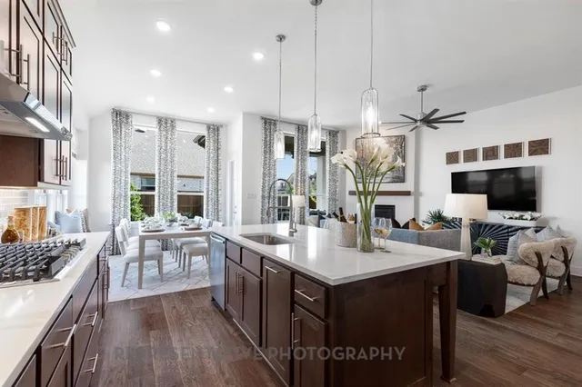 a large kitchen with a table and chairs